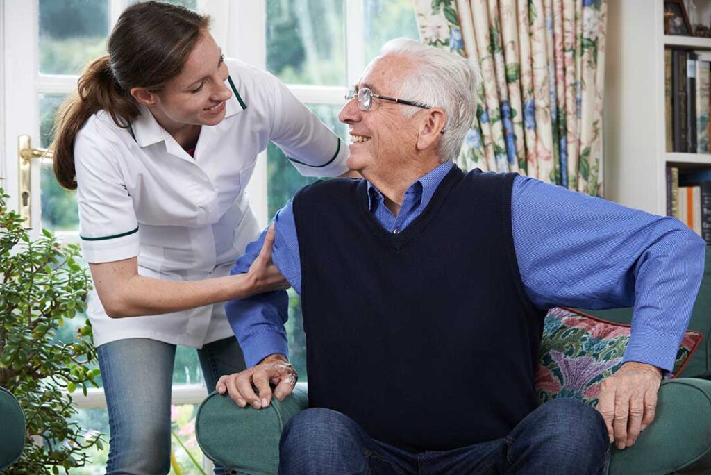 Older adult and family member reviewing home care and assisted living costs at a kitchen table.