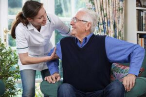 Older adult and family member reviewing home care and assisted living costs at a kitchen table.